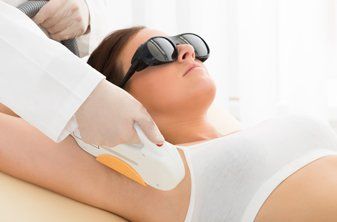 Laser hair removal on woman armpit
