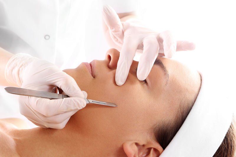 Dermablading woman's face