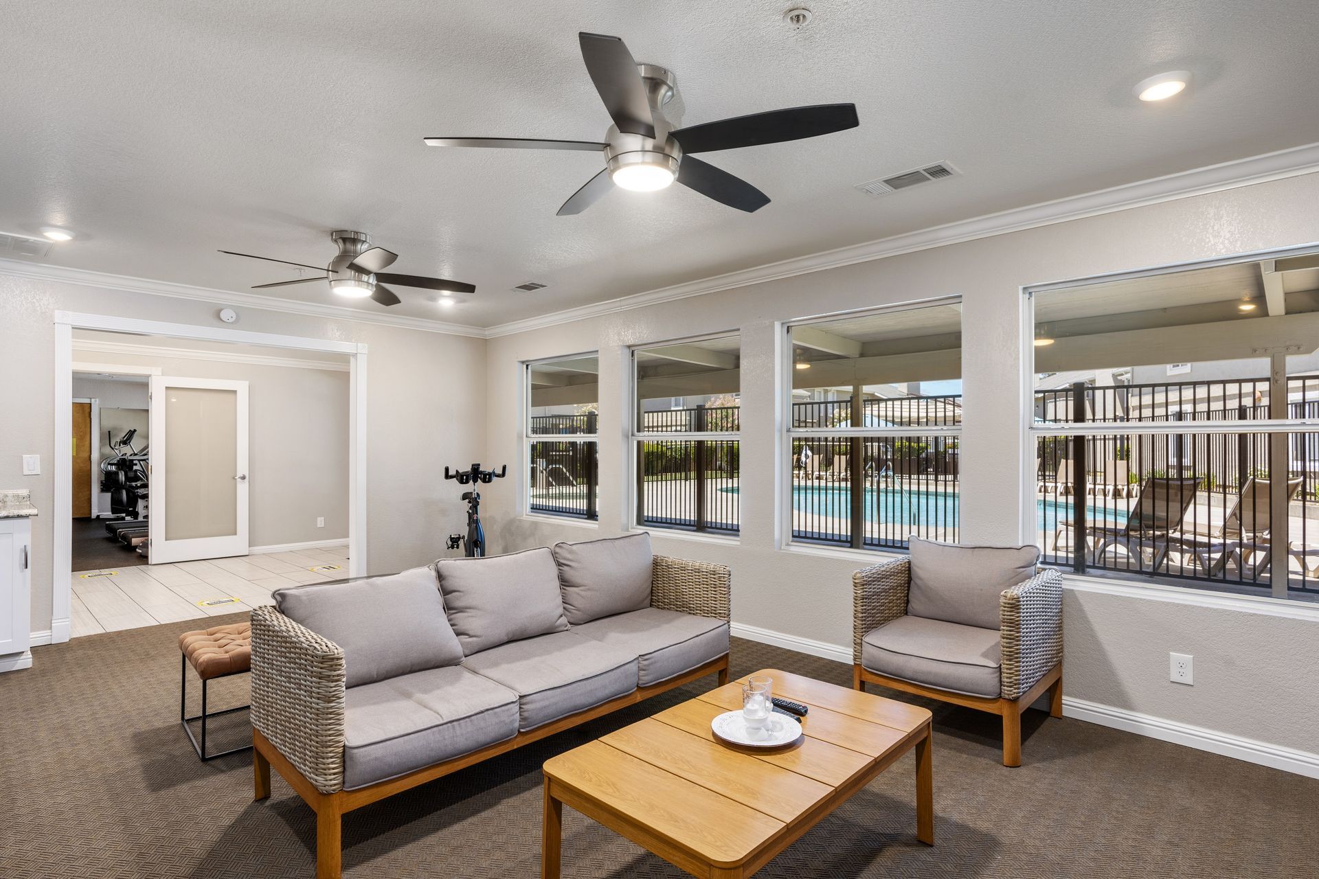 Open book on a tan blanket on a bed with white bedding and pillows, fairy lights in the background.