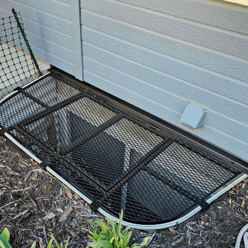 A black fabricated window well cover by 83MetalCraft, LLC