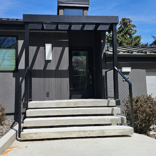 A black custom fabricated Steel pergola and cable railing fabricated and installed by 83MetalCraft, LLC
