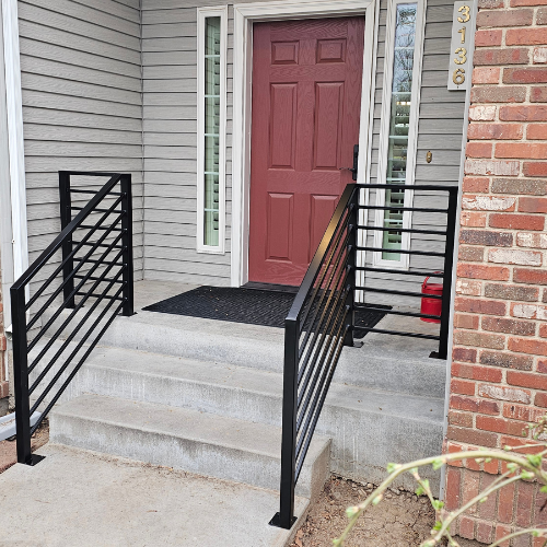 A black horizontal Custom metal railing for a home entrance fabricated and installed by 83MetalCraft, LLC