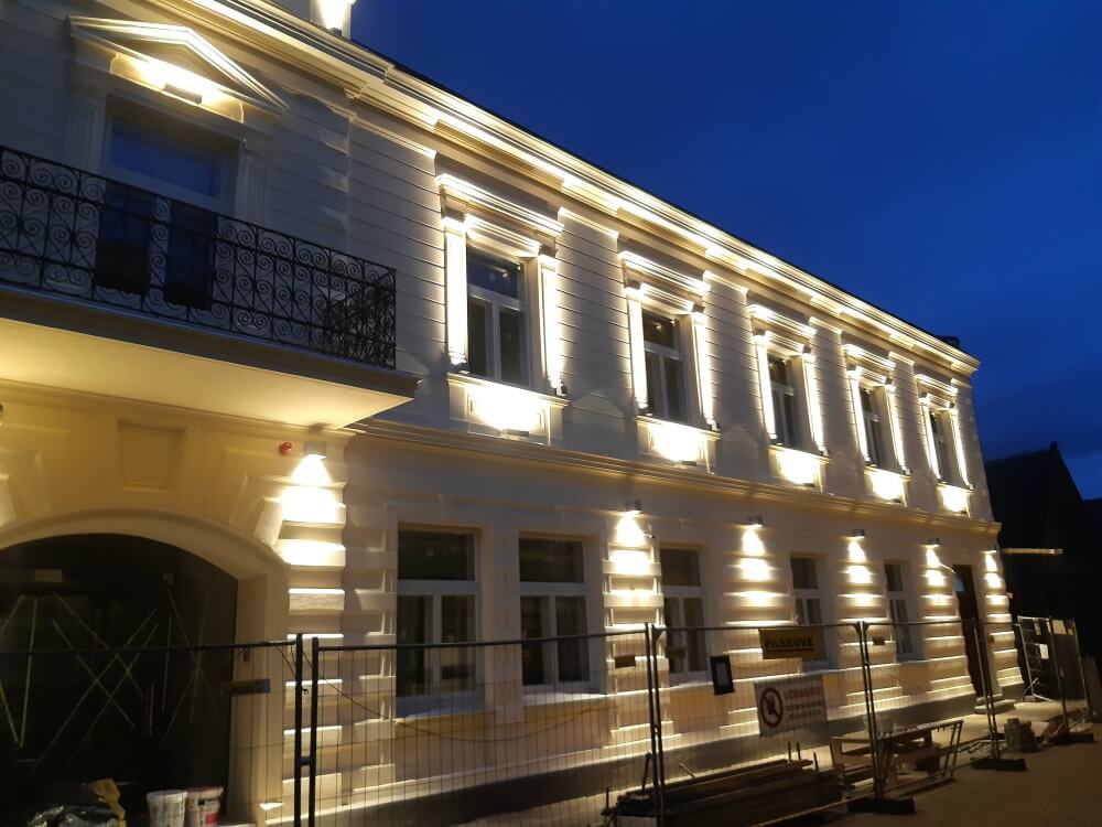 Stone house with yellow finish at night with lighting