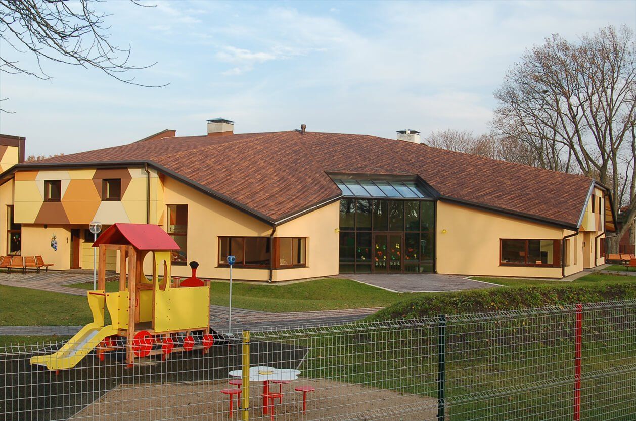 Yellow kindergarten with a playground