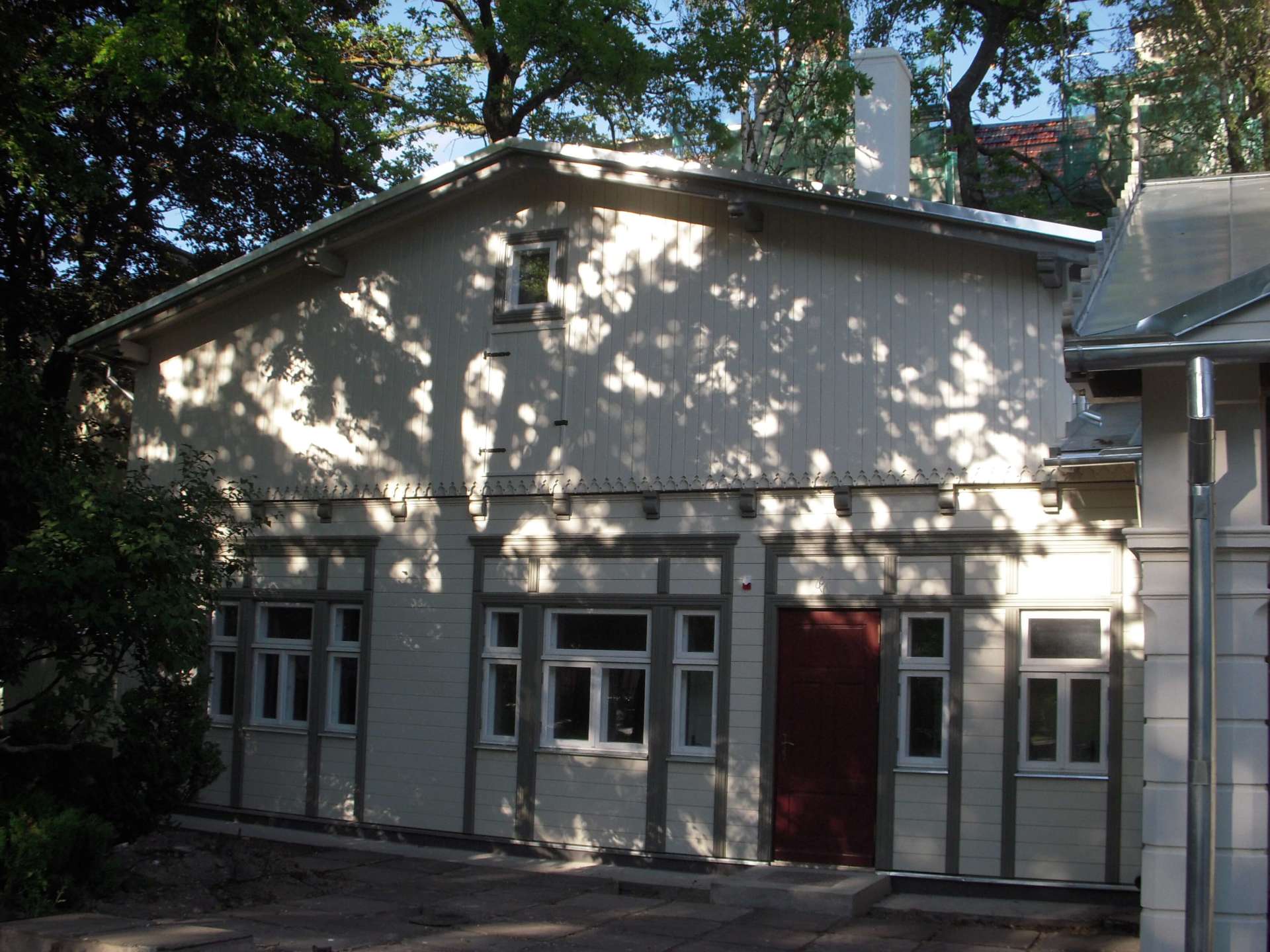 White wooden buildings with red doors