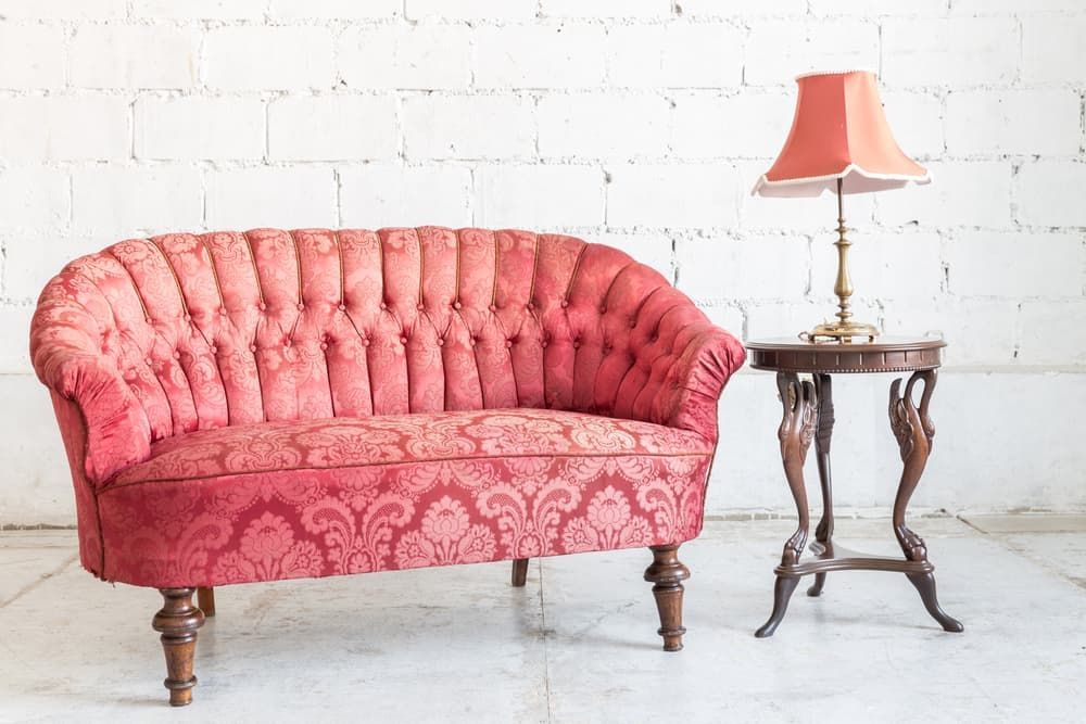 A Red Tufted Settee Vintage Side Table and Lamp — Totally Green Cleaning Solutions in Kambah, ACT