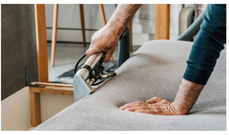 Man Doing An Upholstery Cleaning In Canberra On A Sofa