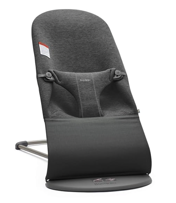 A black baby bouncer is sitting on a white surface