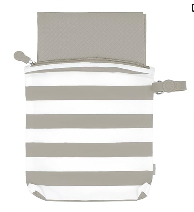 A grey and white striped bag with a zipper and a piece of paper inside of it.