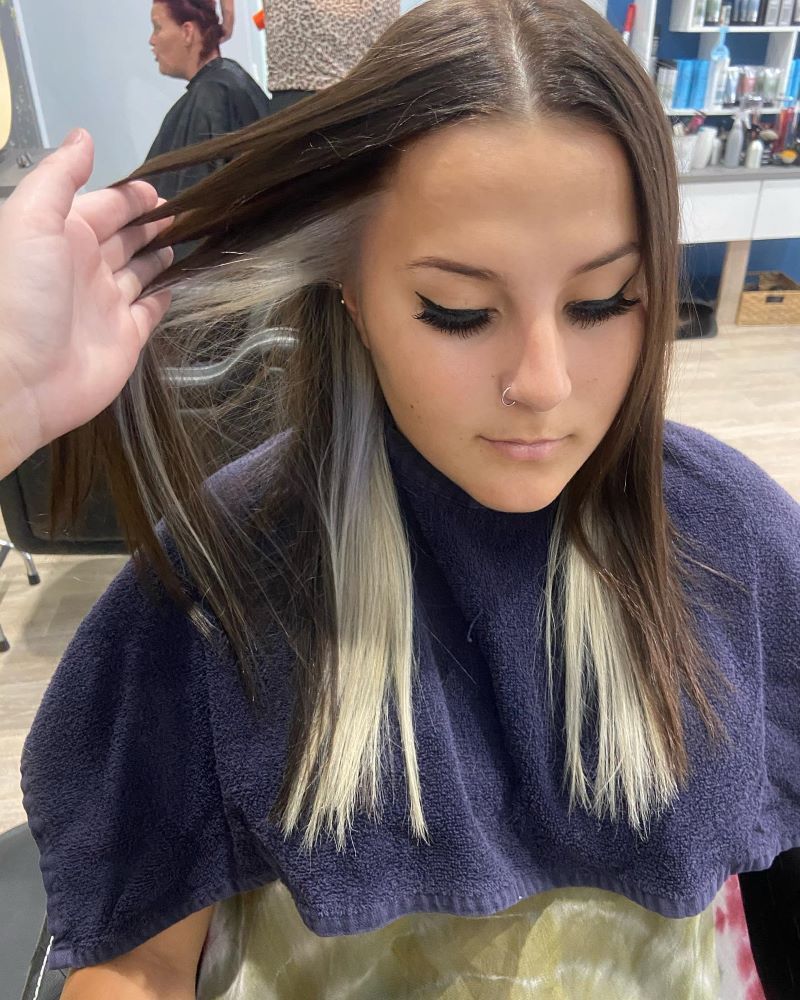A Woman is Getting Her Hair Dyed in a Salon — Fraser Shores Hair Design in Fraser Coast, QLD