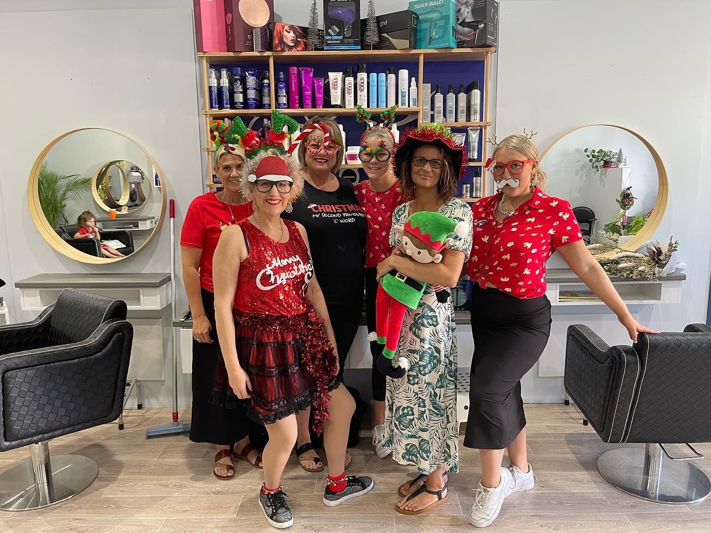 A Woman Is Holding a Certificate — Fraser Shores Hair Design in Urraween, QLD