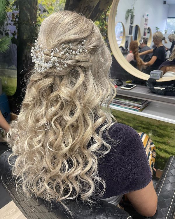 A Woman Is Sitting in A Chair — Fraser Shores Hair Design in Urraween, QLD