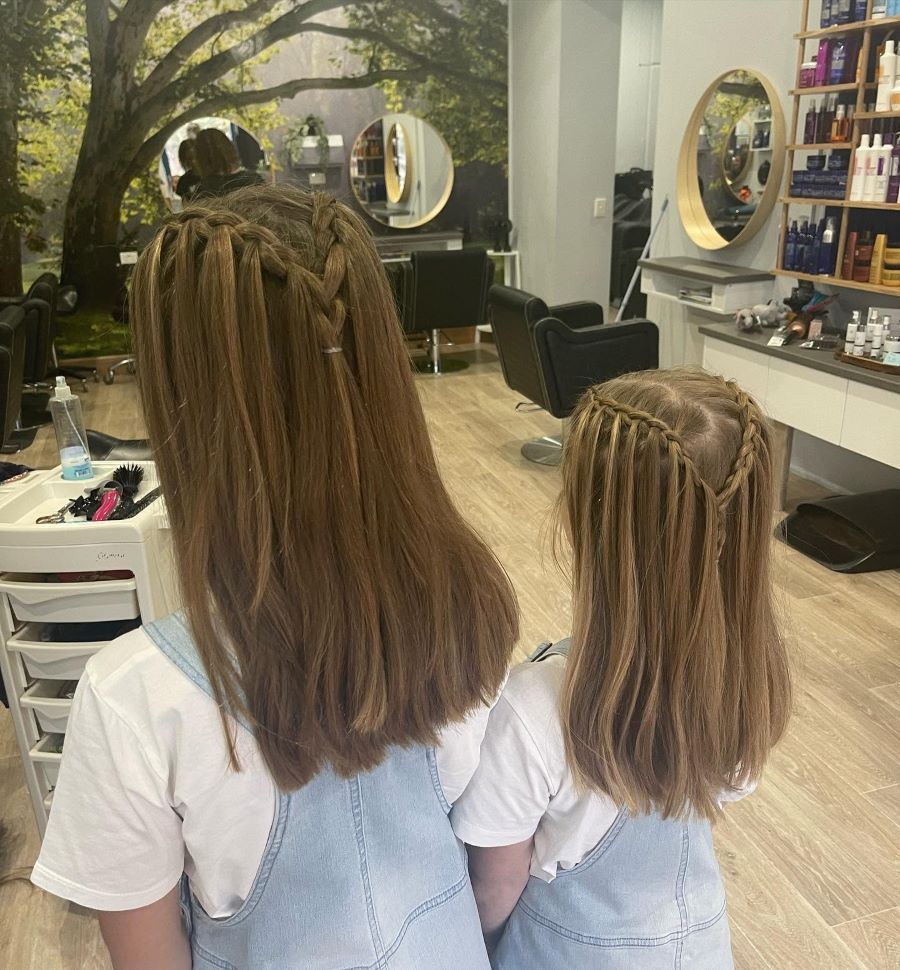 Two Girls Are Sitting Next to Each Other in a Hair Salon — Fraser Shores Hair Design in Fraser Coast, QLD