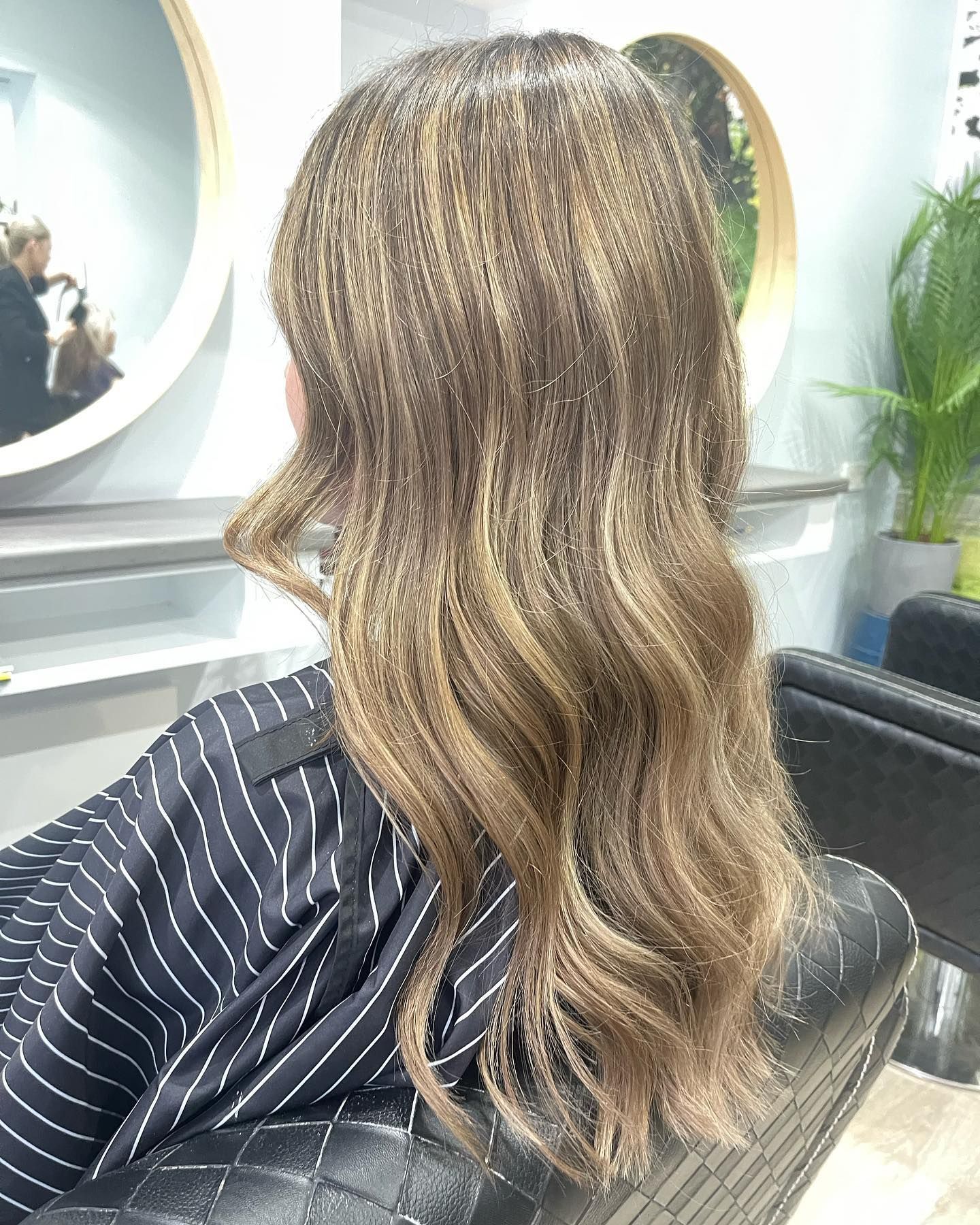 A Woman Is Sitting in A Chair — Fraser Shores Hair Design in Urraween, QLD