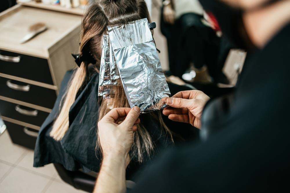 Foil Highlights Being Applied to Hair in A Salon Chair — Fraser Shores Hair Design In Urraween, QLD