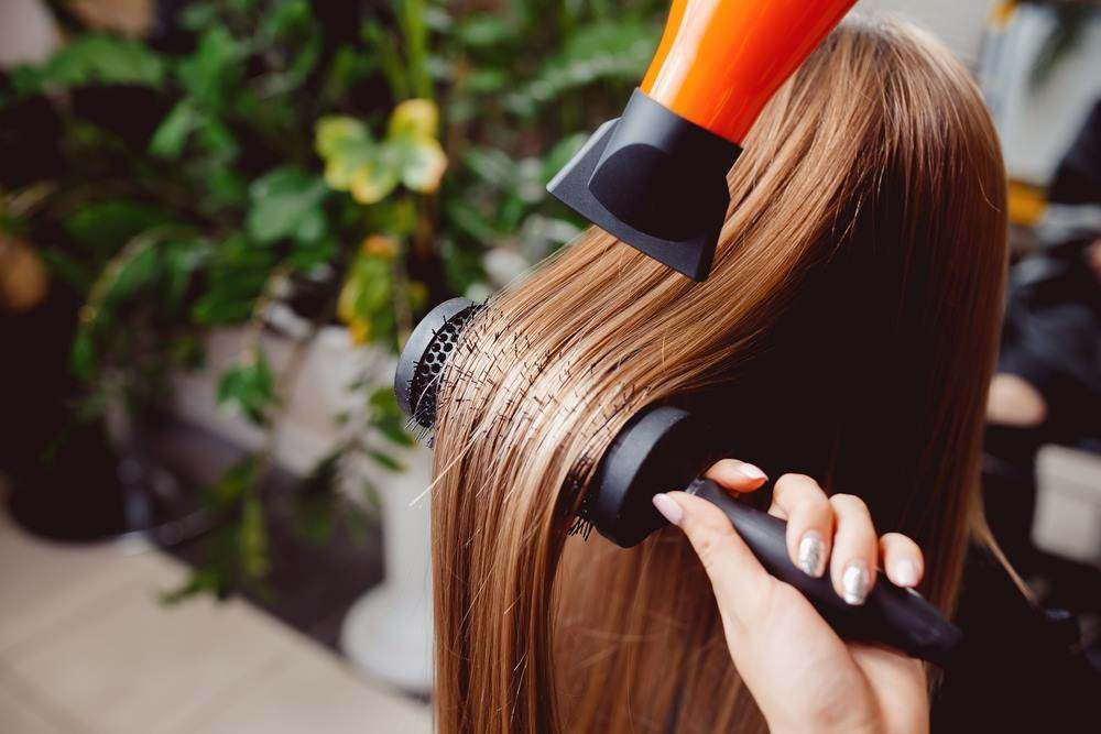 Hair Being Blow-Dried with A Round Brush — Fraser Shores Hair Design In Urraween, QLD