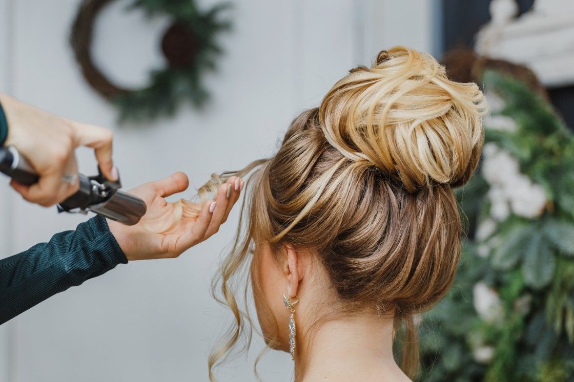 A Blonde Woman is Getting Her Hair Done by a Hairdresser — Fraser Shores Hair Design In Urraween, QLD