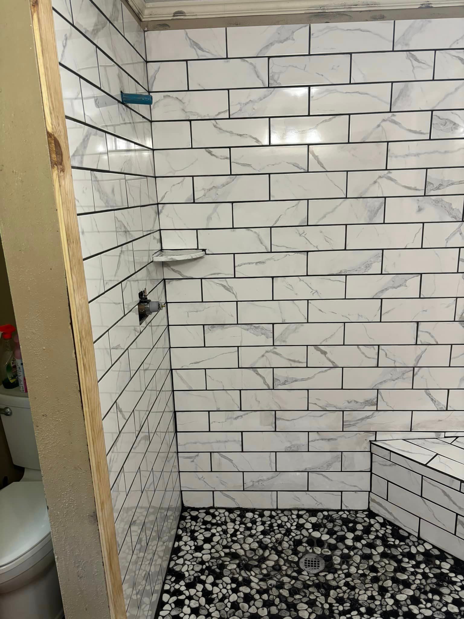 A kitchen under construction with white cabinets and a sink.