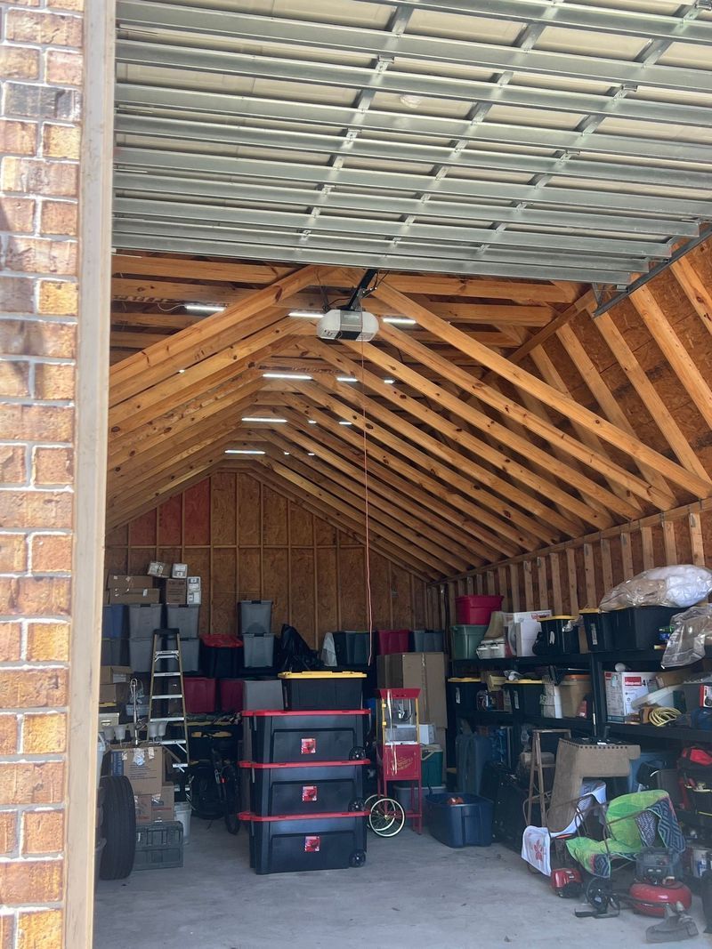 The inside of a garage filled with lots of boxes and shelves