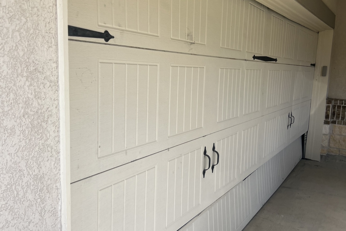 A white garage door with a dollar sign on it