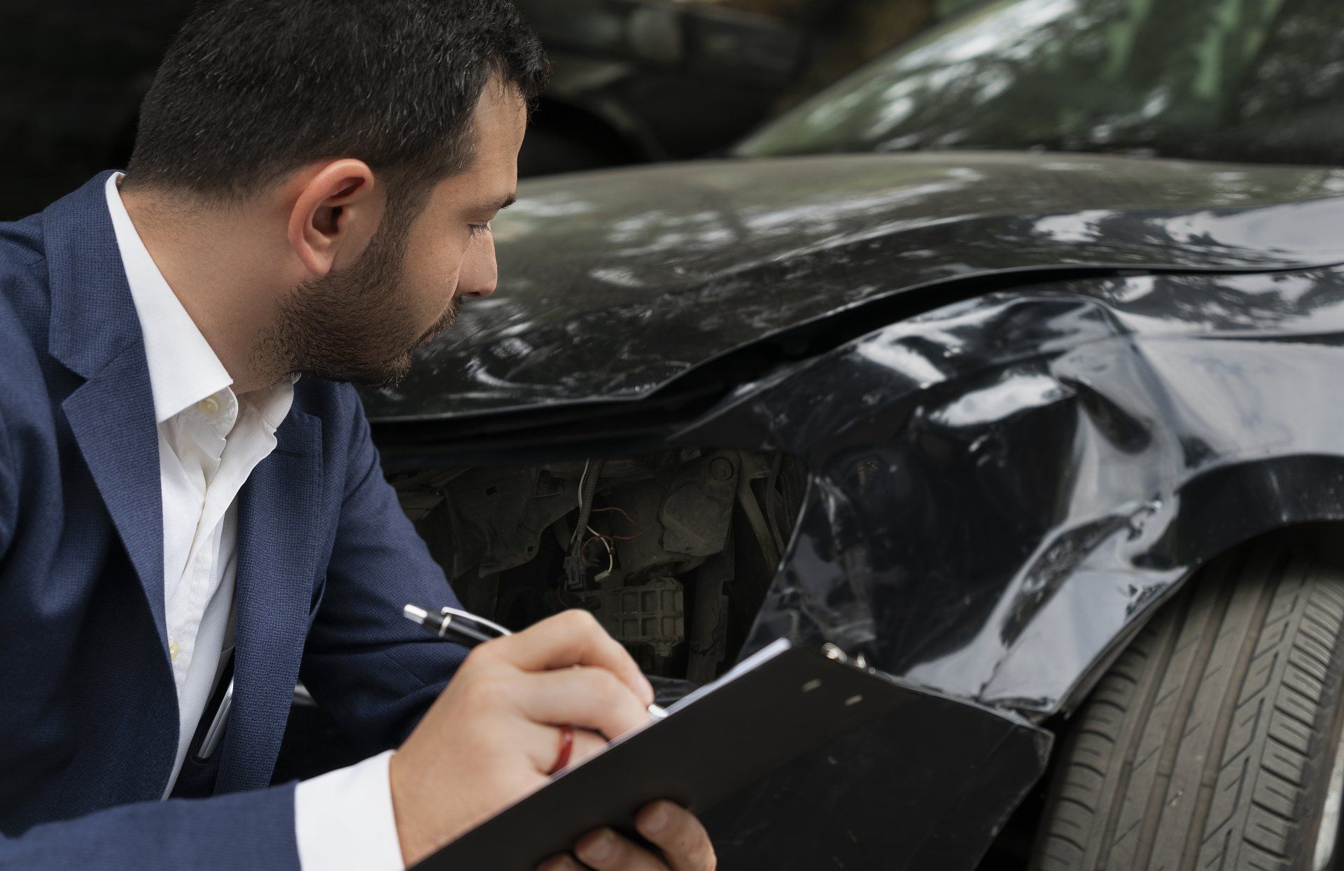 Man Calculating Car Damage  — Muskegon, MI — Nolan Insurance Agency