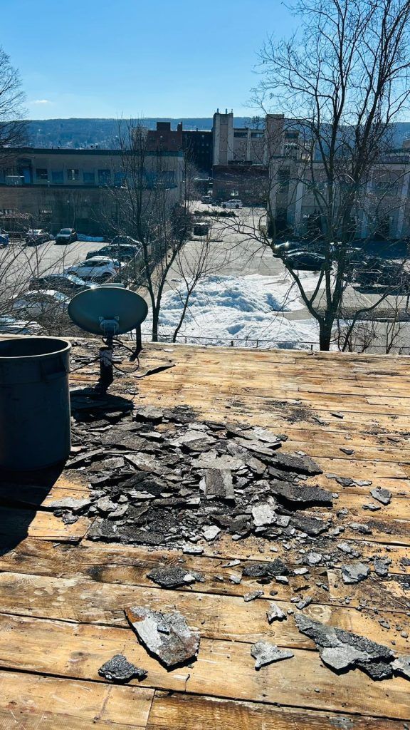 A wooden roof with a satellite dish on top of it.