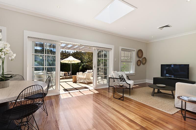 A large white house is being built with a wooden frame.