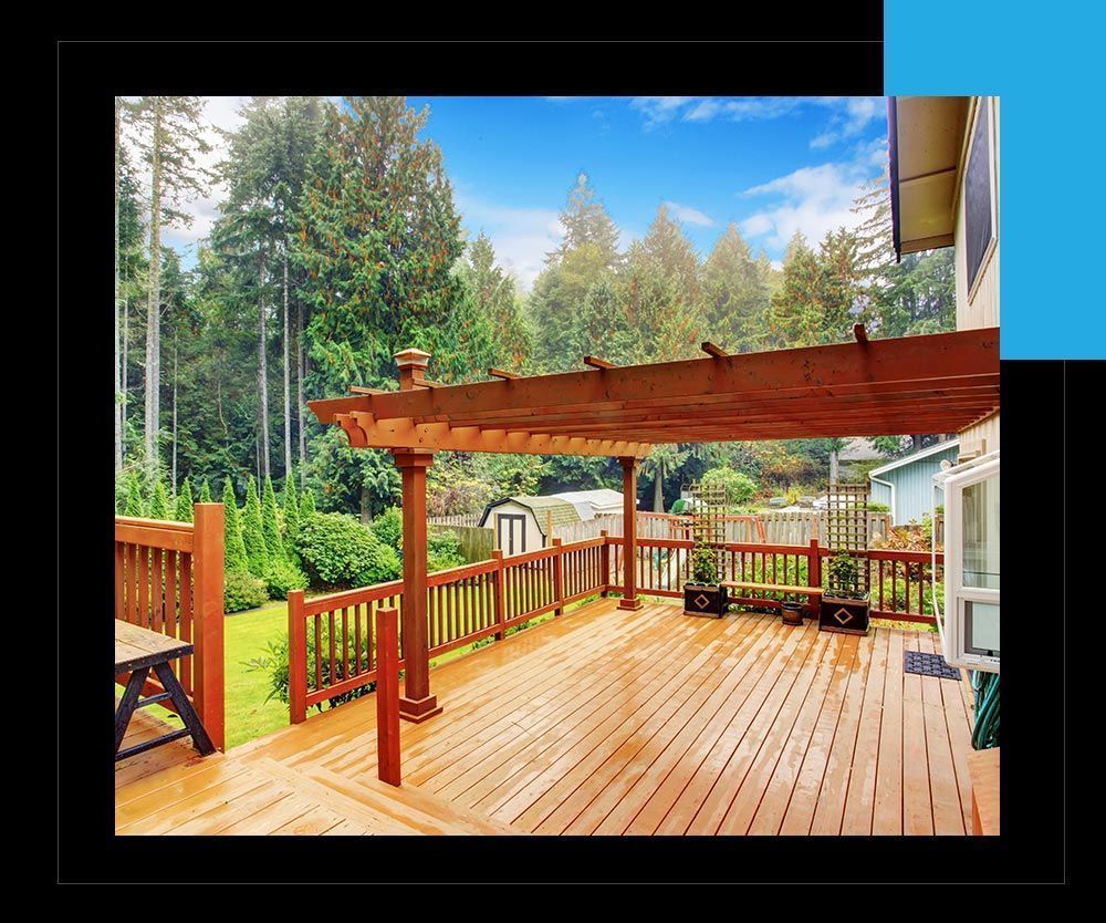 A large wooden deck with a pergola on top of it.