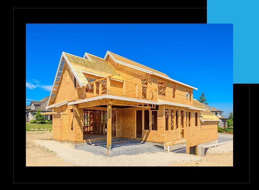 A large wooden house is being built in a residential area.