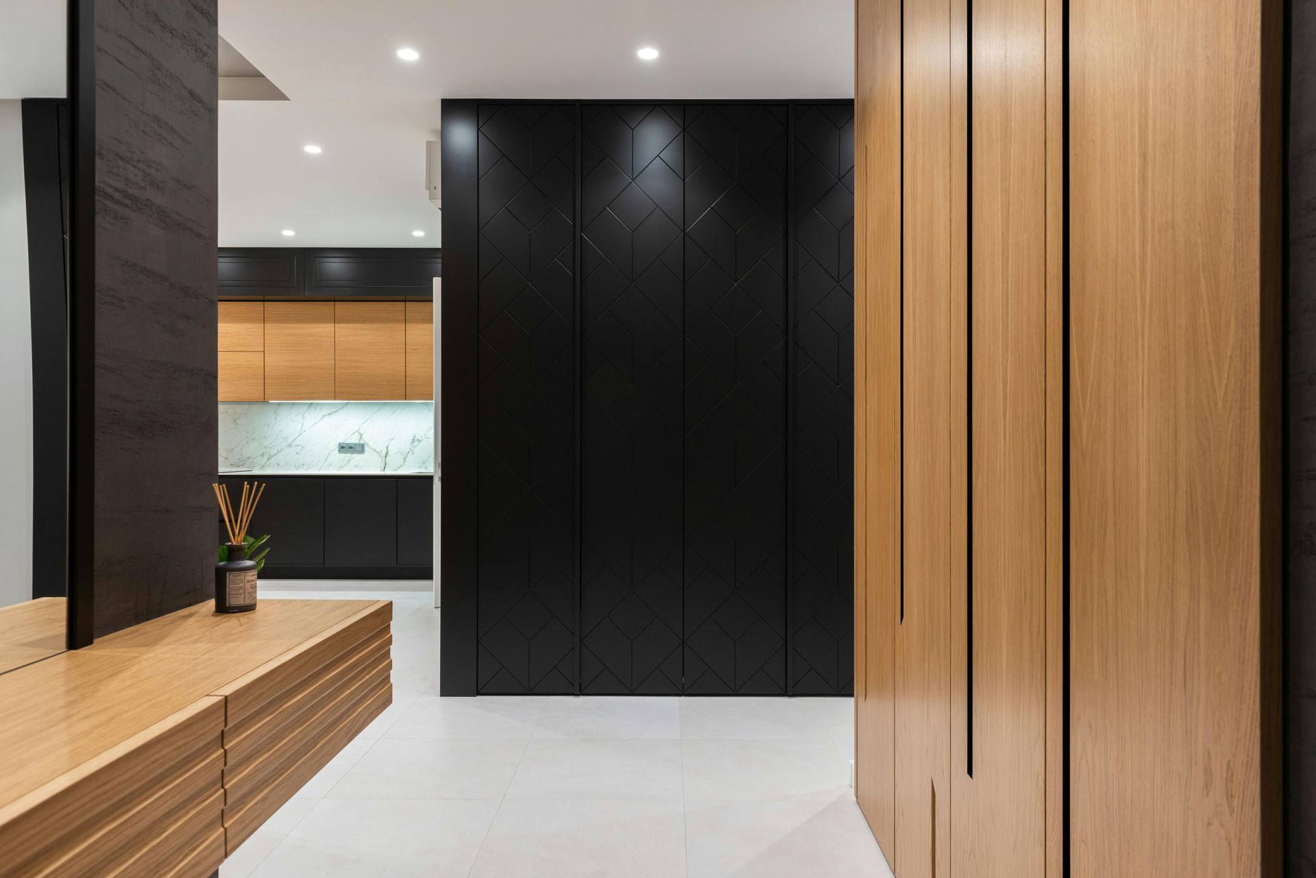 Modern interior with light wood and black paneling, white floors, and a glimpse of a kitchen — Nielsen Construction in Wagga Wagga, NSW