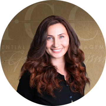 Woman with long, wavy auburn hair smiles, wearing a black shirt, set against a brown background with text.