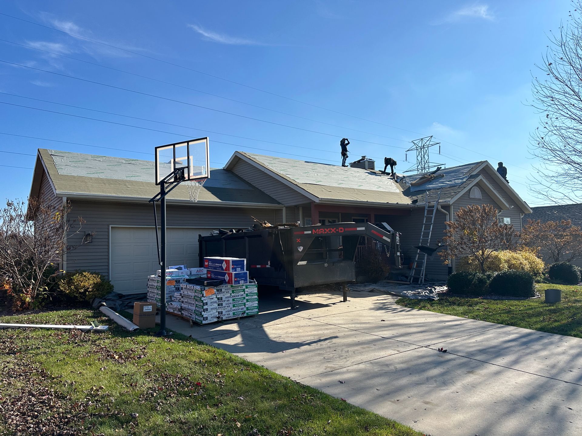 A house with a basketball hoop in front of it.