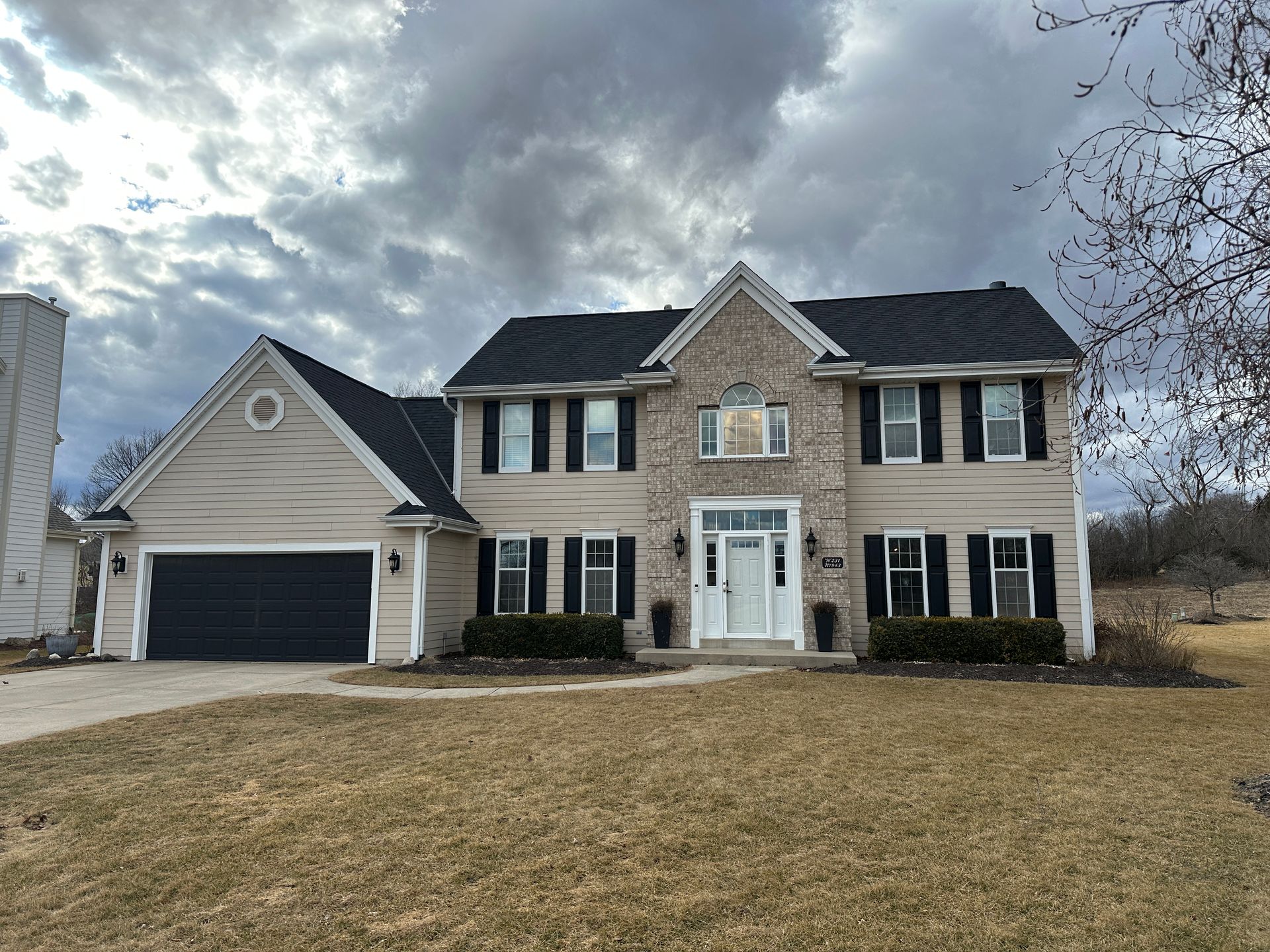 A house with a basketball hoop in front of it.