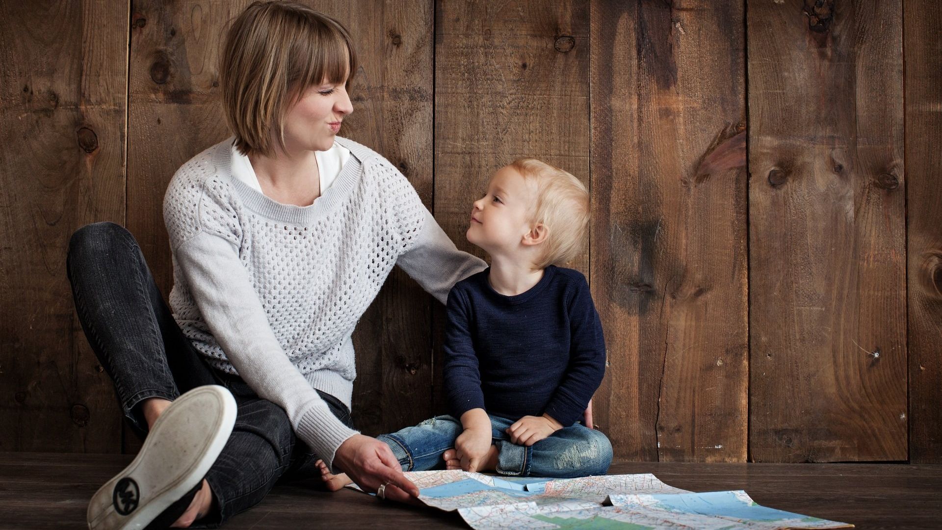 Child and guardian playing with a map