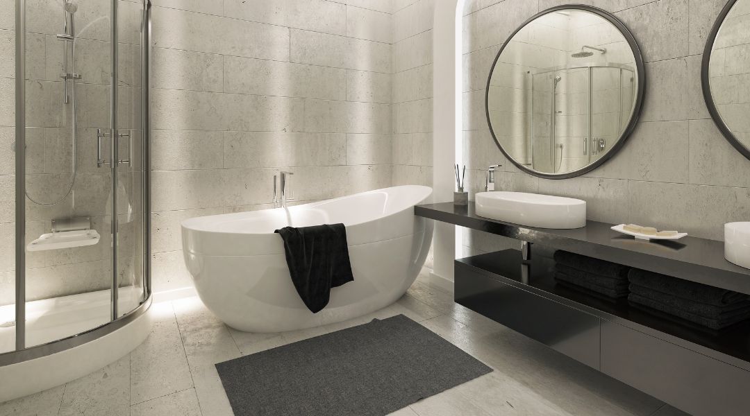 A bathroom with a bathtub , sink , shower and mirrors.