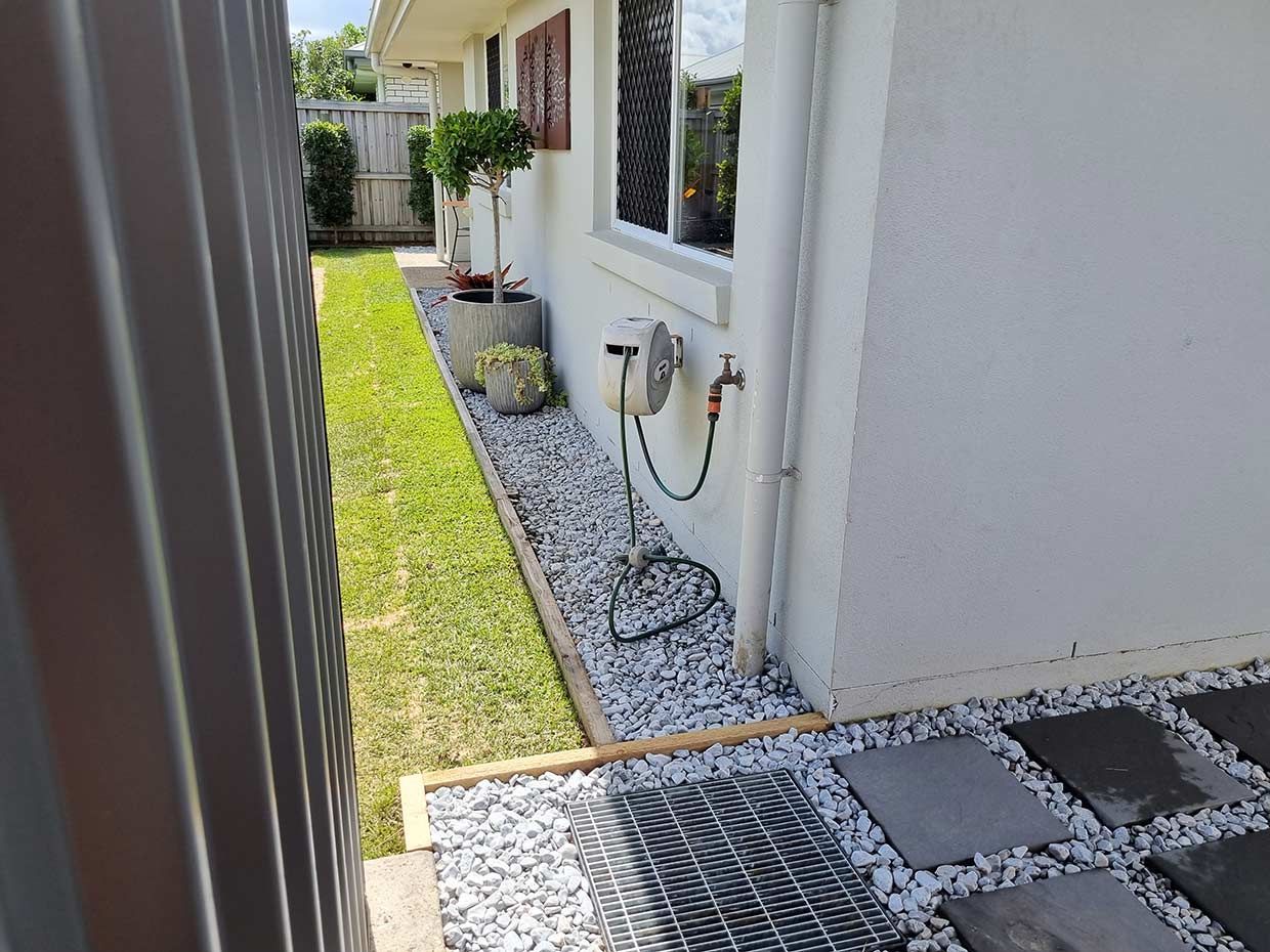 A White House With a Fence and a Lawn in Front of It — All Aspects Landscaping In Peregian Beach, QLD