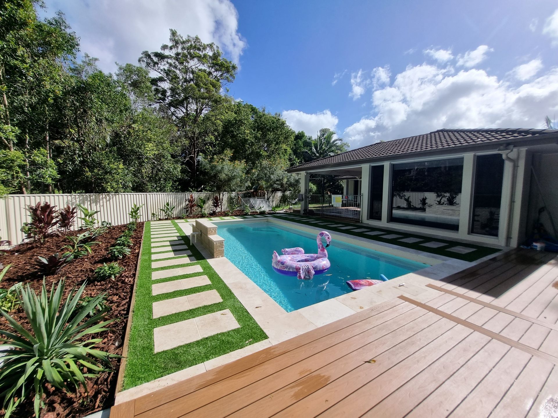 Backyard With a White Fence and a Palm Tree — All Aspects Landscaping In Maroochy River, QLD