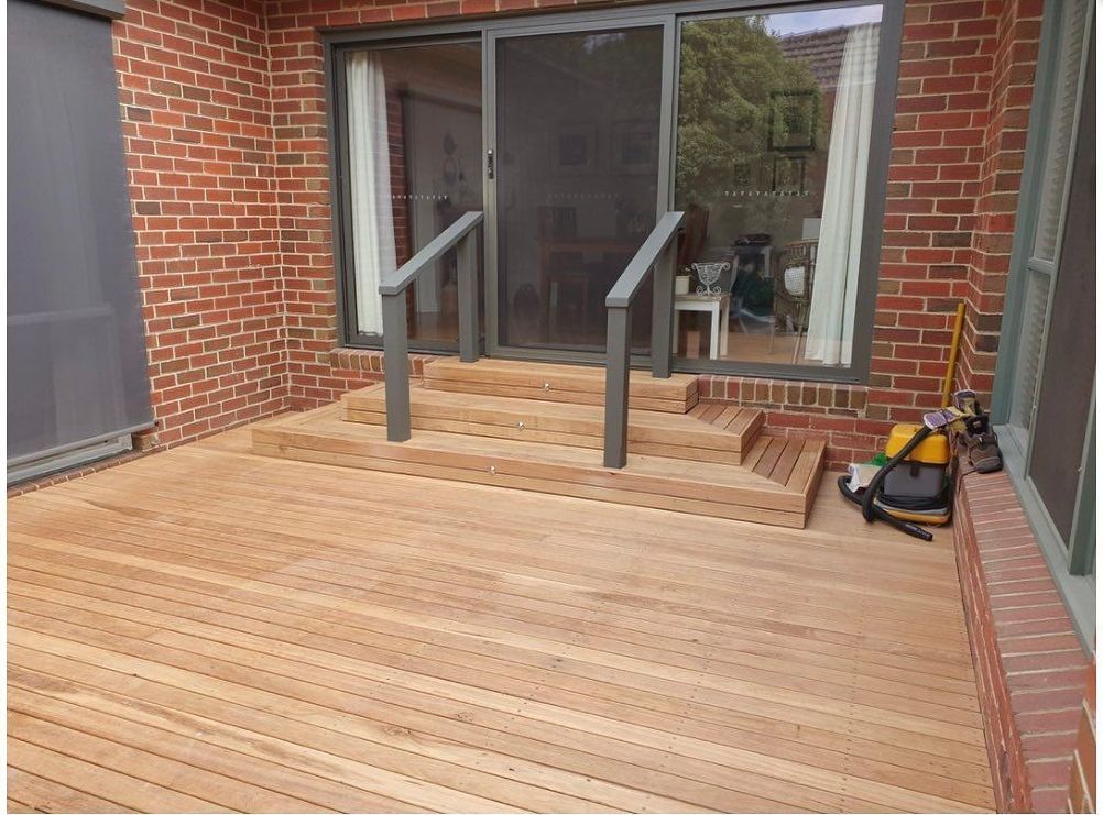 A Wooden Deck With Stairs And A Sliding Glass Door — All Aspects Landscaping In Peregian Beach, QLD