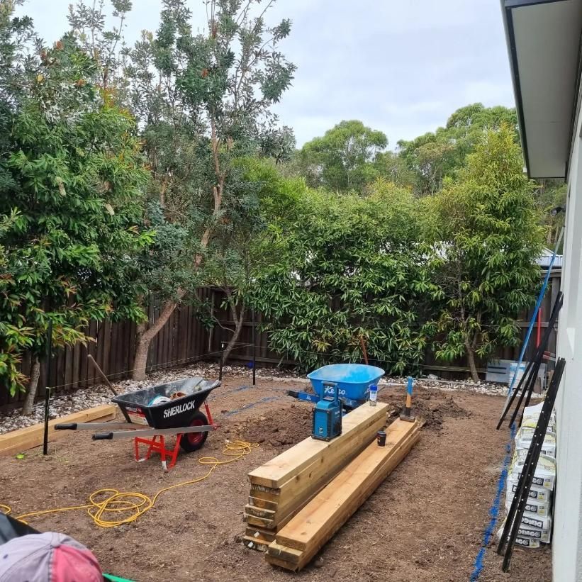 Backyard Under Construction With Lumber, Tools, And Trees In The Background — All Aspects Landscaping In Maroochydore, QLD