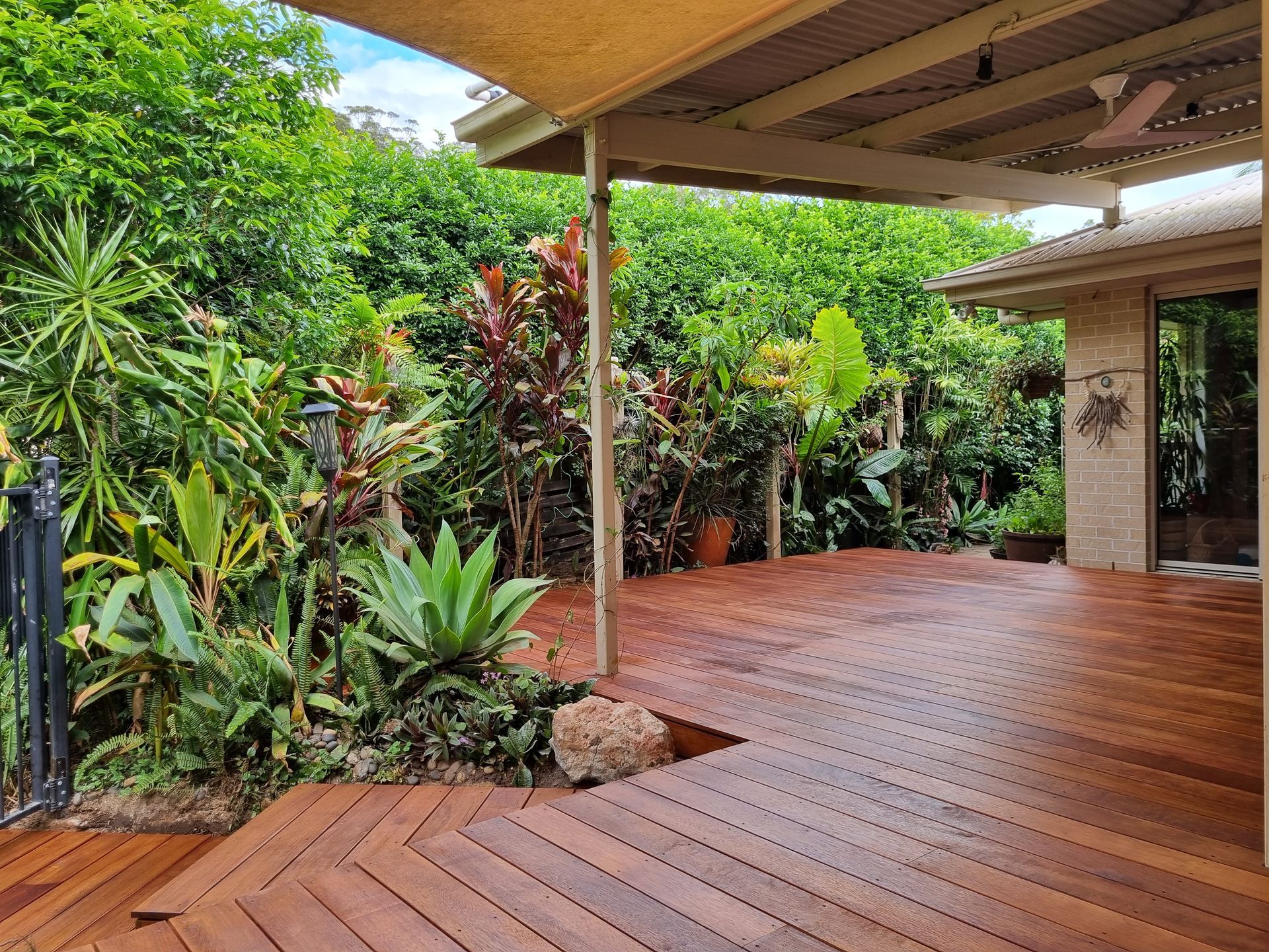 A Wooden Deck Surrounded By Trees — All Aspects Landscaping In Peregian Beach, QLD