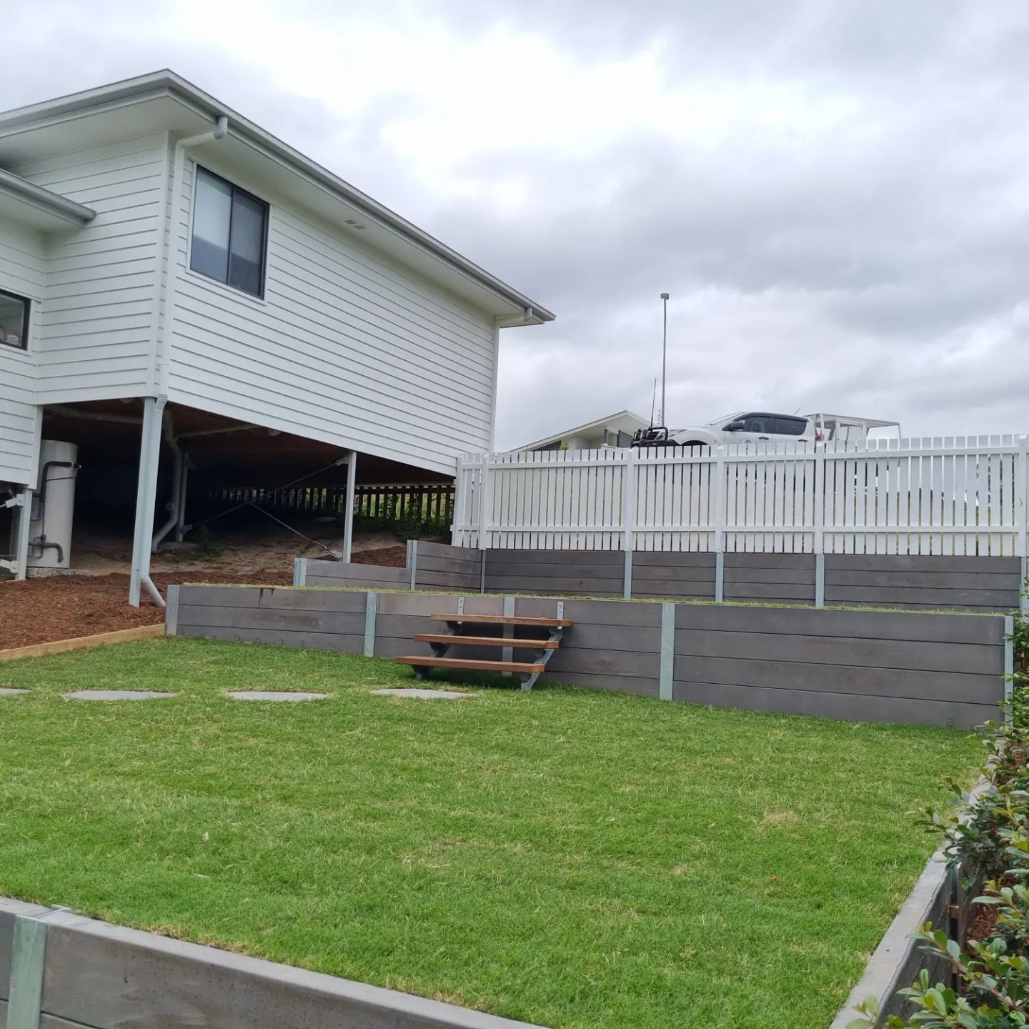 White House with Retaining Wall Built In Front Yard — All Aspects Landscaping In Peregian Beach, QLD