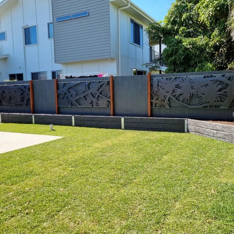 A Fence With A Design On It Is In Front Of A House — All Aspects Landscaping In ﻿Coolum Beach, QLD