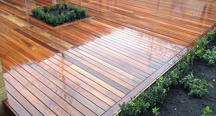 A Wooden Deck With A Planter In The Middle Of It — All Aspects Landscaping In ﻿Coolum Beach, QLD