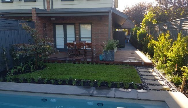 There Is A Swimming Pool In The Backyard Of A House — All Aspects Landscaping In Peregian Beach, QLD