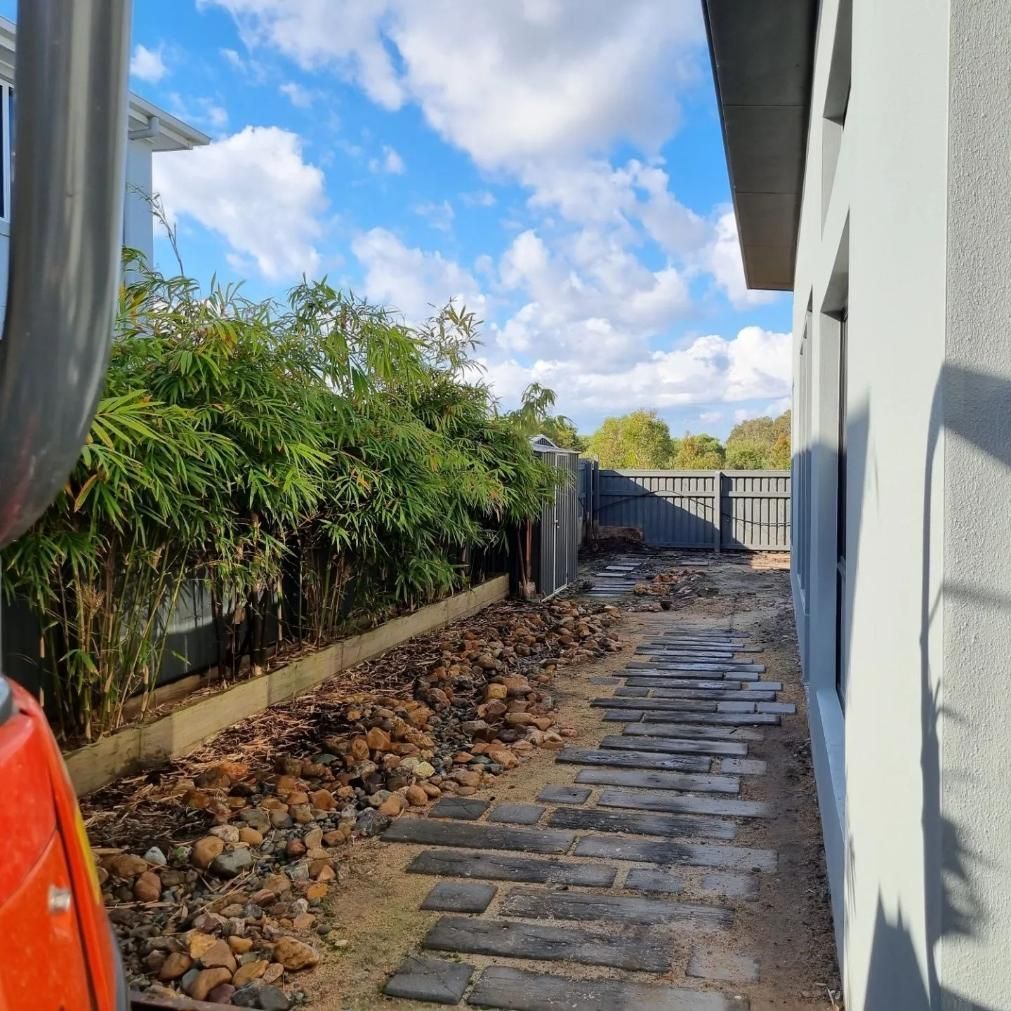 A Brick Walkway Leading To A House With A Fence In The Background — All Aspects Landscaping In Buderim, QLD