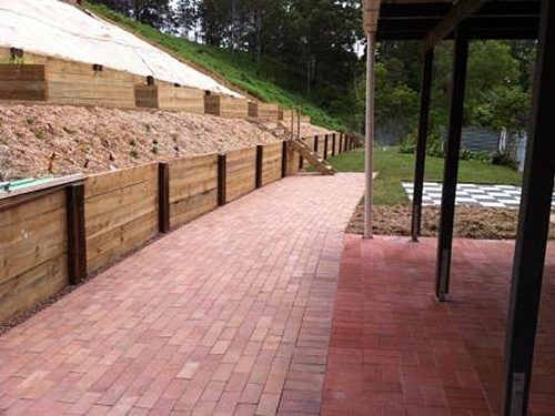 A Brick Walkway Leading To A Wooden Retaining Wall — All Aspects Landscaping In Peregian Beach, QLD