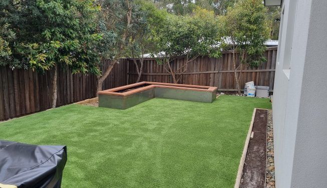 A Backyard With A Lot Of Grass And A Fence — All Aspects Landscaping In Peregian Beach, QLD