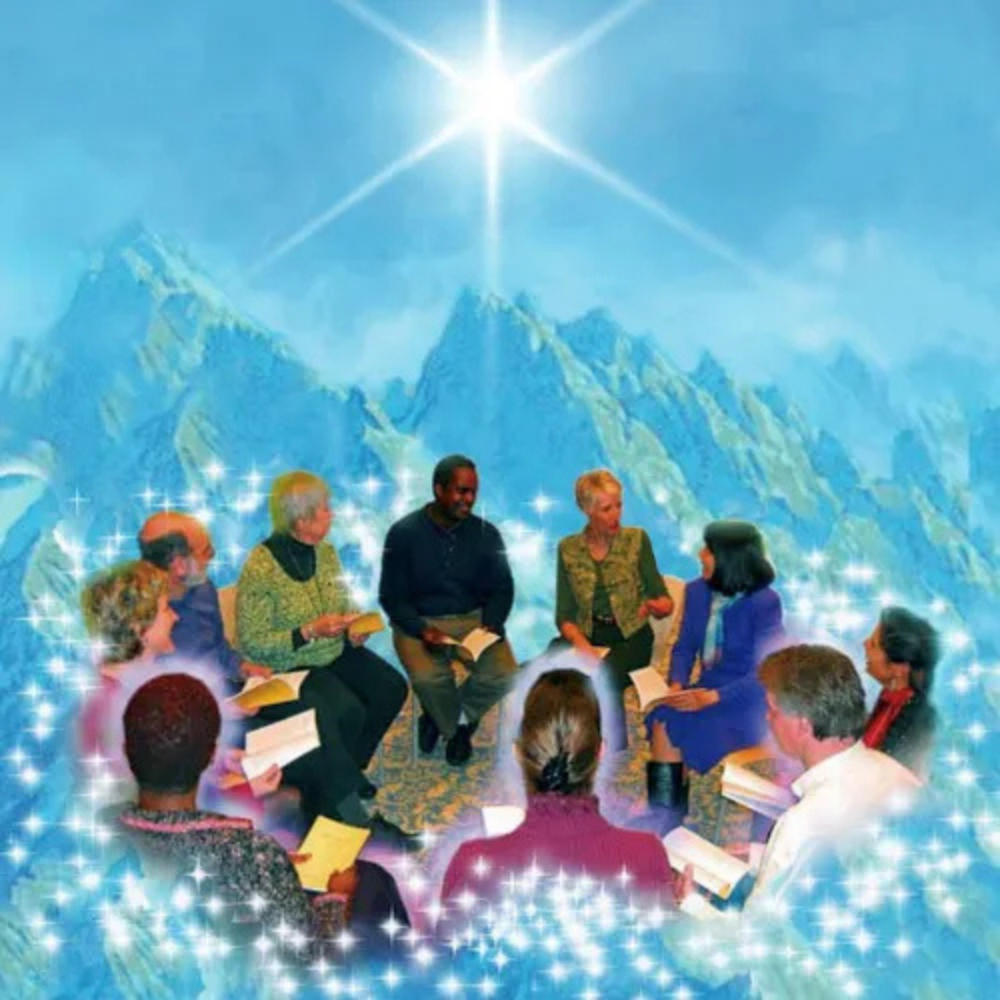 A group of people are sitting in a circle with mountains in the background