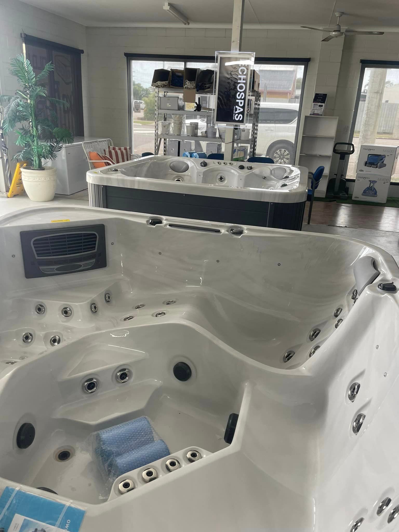 Large White Jacuzzi Tub Is Sitting In A Room — ECHO Spas in Garbutt, QLD