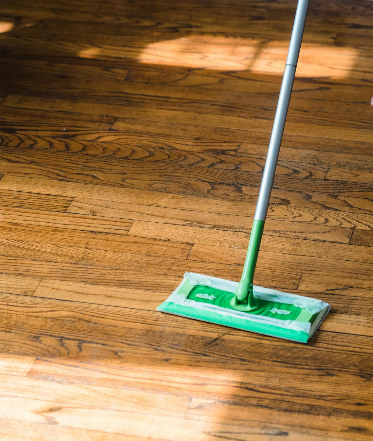 dry mop cleaning a hardwood floor surface